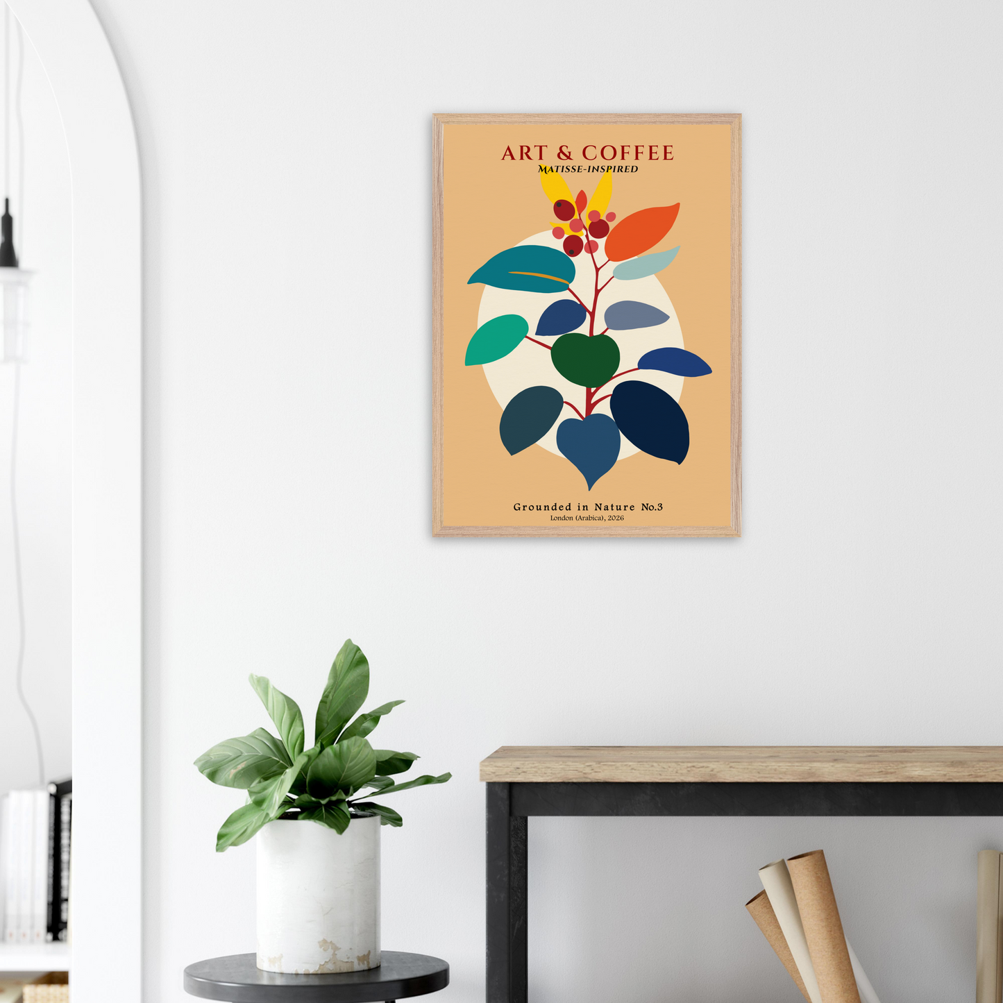 Matisse-style framed artwork with colourful leaf design on a wall above a desk.